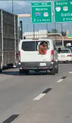 Shirtless inmate hangs out back of corrections van speeding down Oklahoma freeway, while pleading for help: insane video